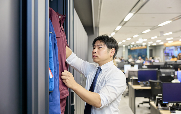 ロッカーを開け、報道局の備品を確認している八幡原さんの様子。